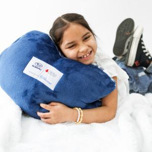 child holding a pillow