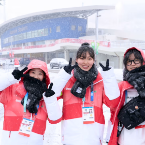 3 people make peace signs with their hands