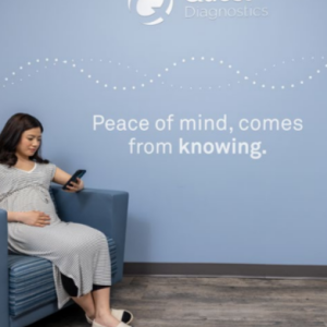 A person seated in a chair, looking at a cellphone. "Peace of Mind, comes from knowing."