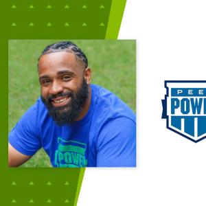 Marlon Ross Jr. central, sitting on grass. Peer Power logo to the right.