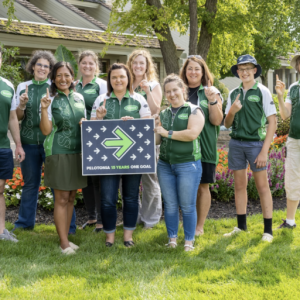 A team posed with a Pelotonia sign, each holding up one finger.