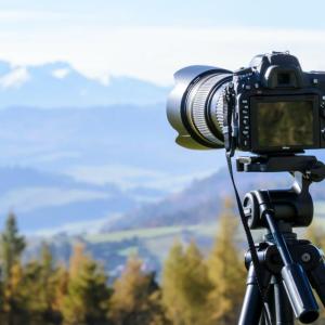 Camera on a tripod looking out over a mountain landscape