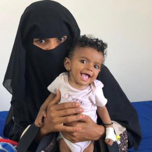 In Yemen, Maimuna, 21, sits with her 8-month-old daughter, who is receiving treatment for severe acute malnutrition.