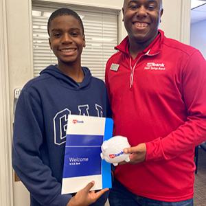 'Ella the Banker' author Liam Okolloh, left with branch manager Ramone Davis.