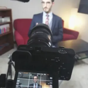 Ruggero Rollini in an interview, focused image on a camera screen.