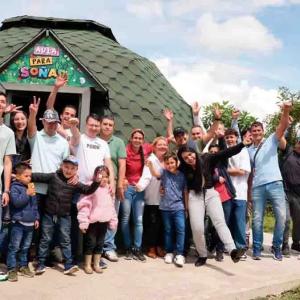A group of adults and children posed cheering.