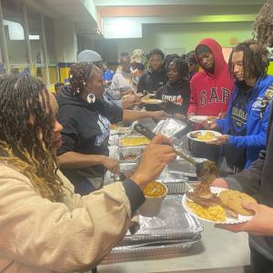 Pittsburgh City League in line for food being served by others.