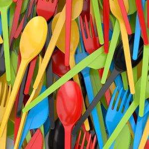 Close up of a pile of colorful plastic cutlery