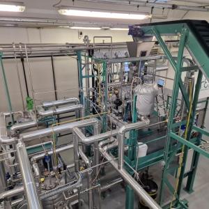 A large machine with many pipes in a large open room.
