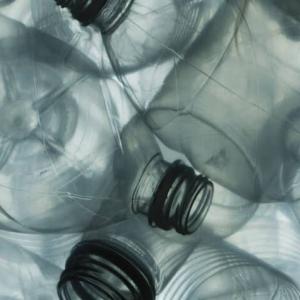 close up to a pile of clear plastic bottles.