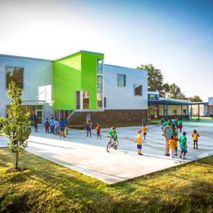 Children playing in a courtyard outside a building.