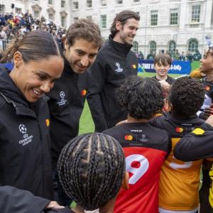 Children and adults gathered on a soccer field.