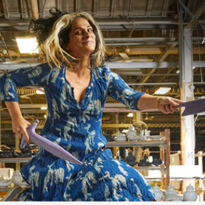 Sarah Kahn jumping in the air with ceramic knives.