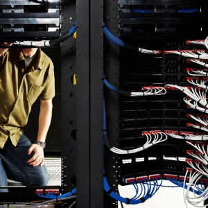 person in front of giant mainframe