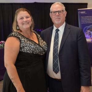 Two people posed in formal attire