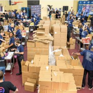 volunteers packing food into boxes