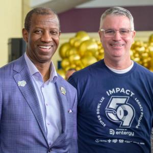 two people standing together and smiling