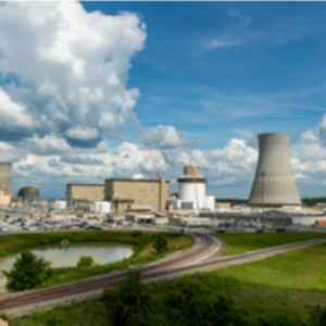 Panoramic view of a power station, partly cloudy sky.