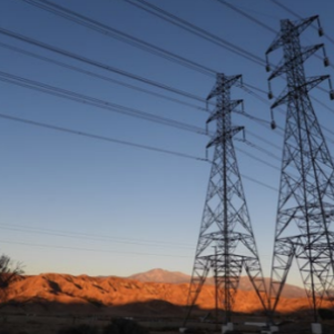 two electricity towers in a desert landscape