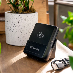 card reader in a window sill next to a potted plant