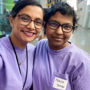 Two people in matching purple shirts
