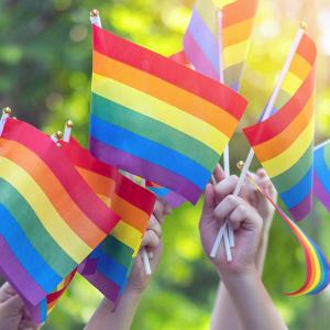Hands waving pride flags