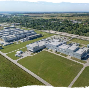 aerial view of many production buildings and driving lanes over a large field