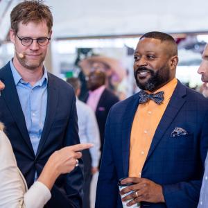 Four people standing in a group talking