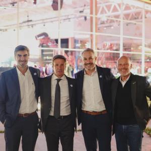 Four people standing in front of dealership