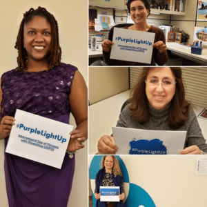 Employees holding #PurpleLightUp signs
