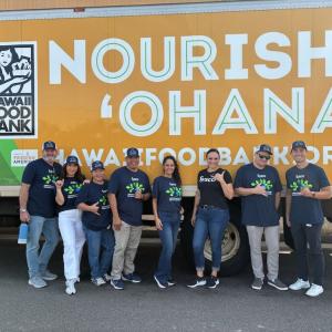 people standing in front of a "Nourish 'Ohana" truck