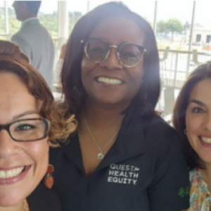 Three smiling people taking a selfie.