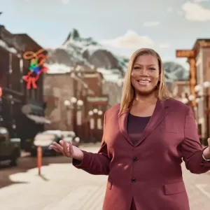 Queen Latifa on a small town main-street. Mountains in the distance