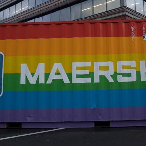 Shipping container painted with rainbow stripes, Maersk and Dow logos on the sides
