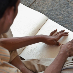 Someone using a brail book