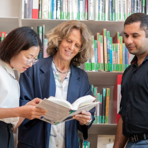 Three people reading a book