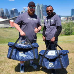 Wesco Cares volunteers smiling and holding blue bags