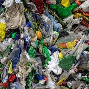 Close up of a pile of flattened plastic containers.