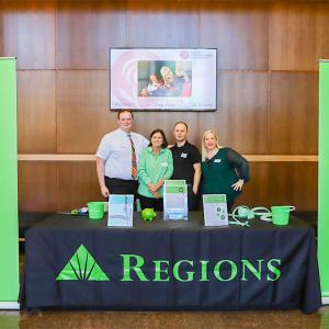 regions booth with four people standing behind it
