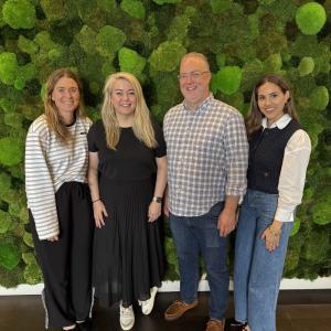Four people standing together