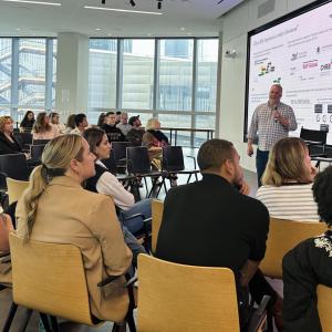 Seated people listening to a speaker