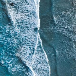 Aerial view of waves against a shoreline