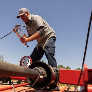 Michael Dalton repairing farm machinery