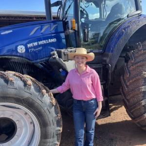 A person standing by a tractor