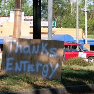 A spray-painted piece of plywood that says "Thanks Entergy"