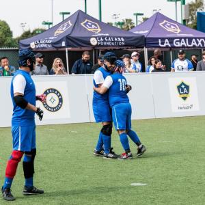 Team celebrate a moment on the field, highlighting the inclusive environment that allows athletes of all abilities to experience the game of soccer.