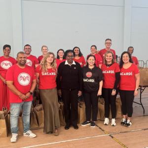 Bacardi employees next to bags