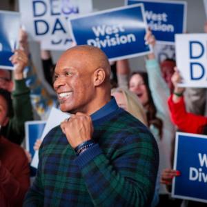 Rich Jennings in front of people holding DE&I signs