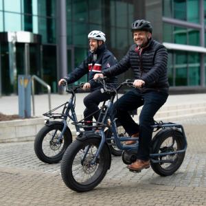 Pete Bowker and Daniel Usher riding e-bikes.