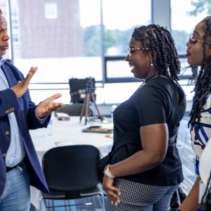 Robert A Winn talking with three others